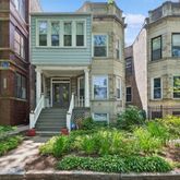 front view of a brick house with a yard