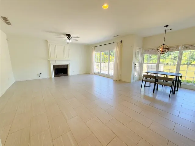 an empty room with furniture and a chandelier