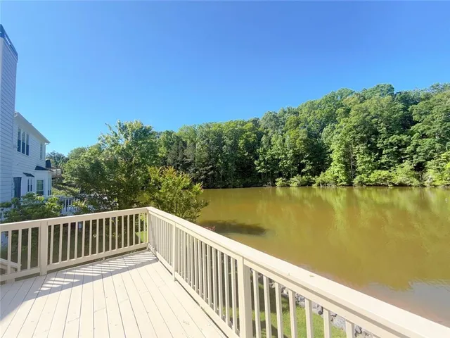 a view of a house with a wooden fence