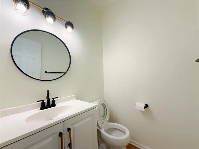 a bathroom with a sink a mirror and a toilet