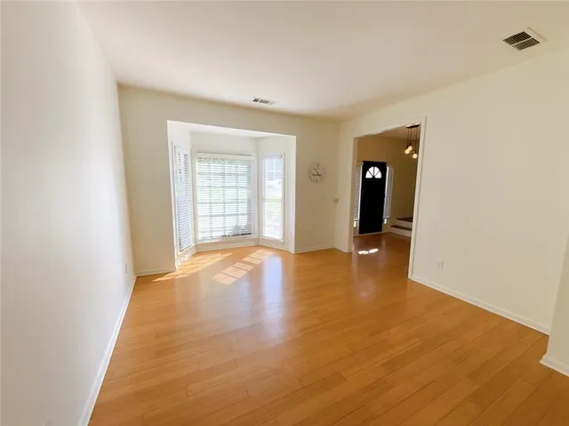 a view of an empty room with glass door