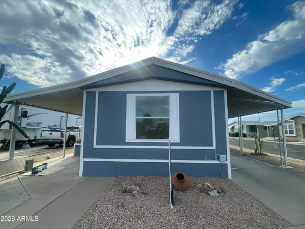 a kitchen with stainless steel appliances a dining table chairs stove refrigerator and cabinets