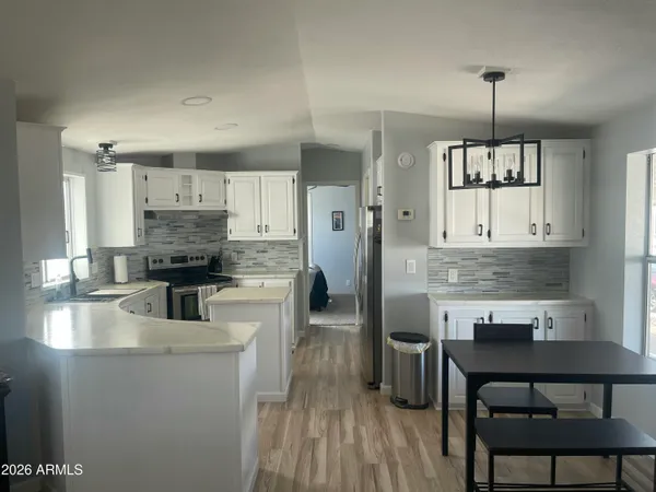 a kitchen with a table and chairs in it