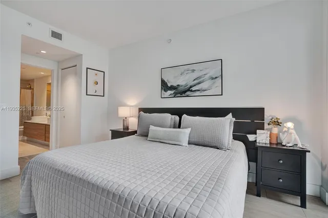 a bedroom with a bed and a lamp