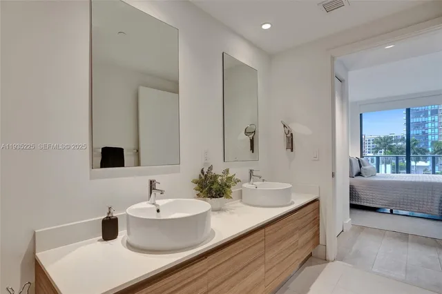 a bathroom with a double vanity sink and a mirror