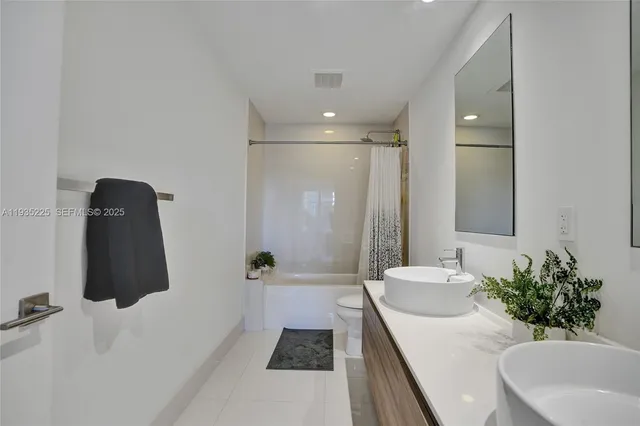 a bathroom with a double vanity sink and a mirror