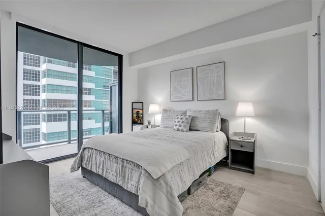 a bedroom with a large bed and a large window