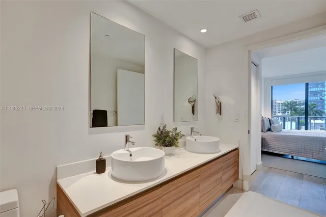 a bathroom with a sink and a mirror with toilet