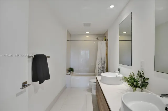 a bathroom with a tub sink and mirror