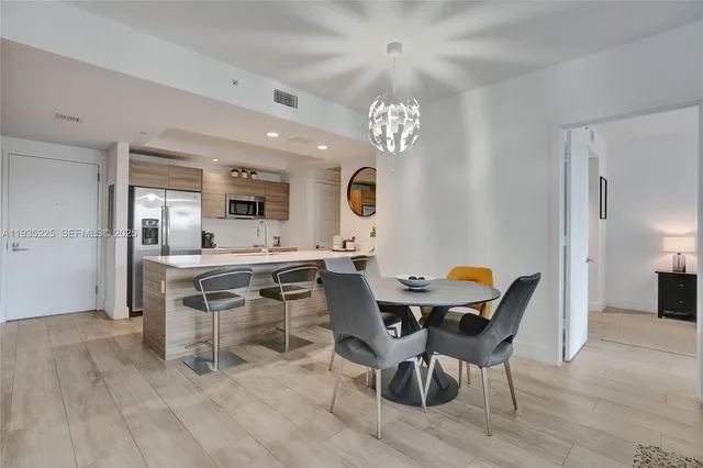 a view of a dining room with furniture and chandelier