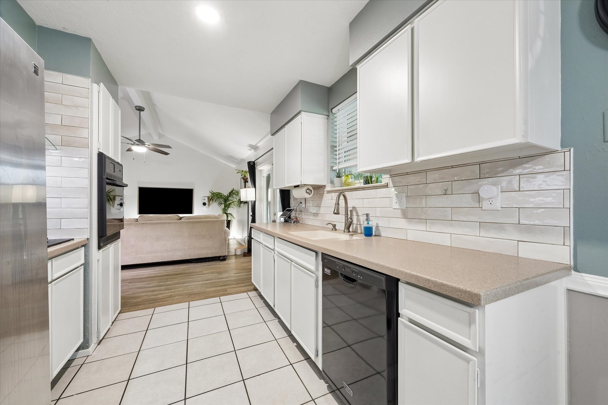 1931 Westlake Road Houston, TX 77062 - Photo 14 of 28 Practical and refreshingly modern, this kitchen connects the dining area on one end with the family room on the other, making it easy to stay part of the action while dinner is underway.