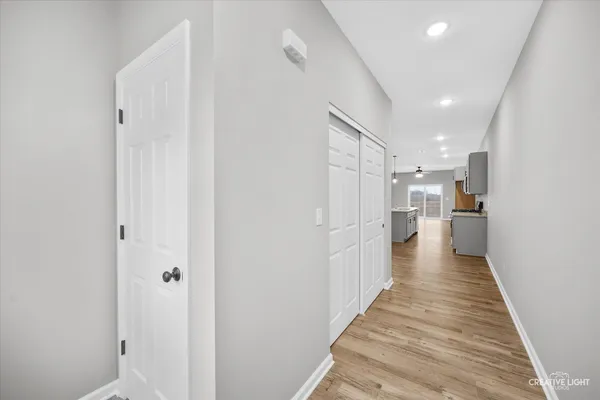 a view of a hallway with wooden floor