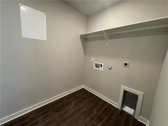 a room with a wooden floor and small window