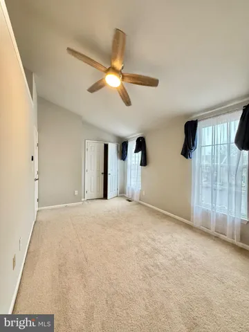 a view of empty room with ceiling fan