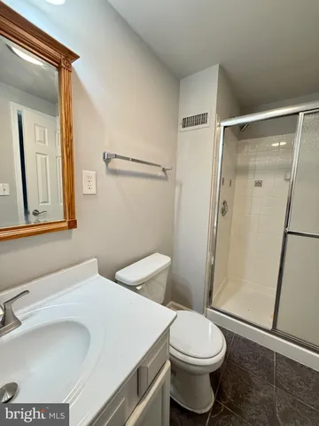 a white toilet sitting next to a bathroom sink