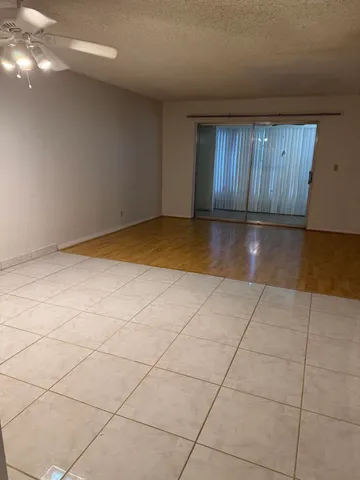 a view of a livingroom with an empty space and a window