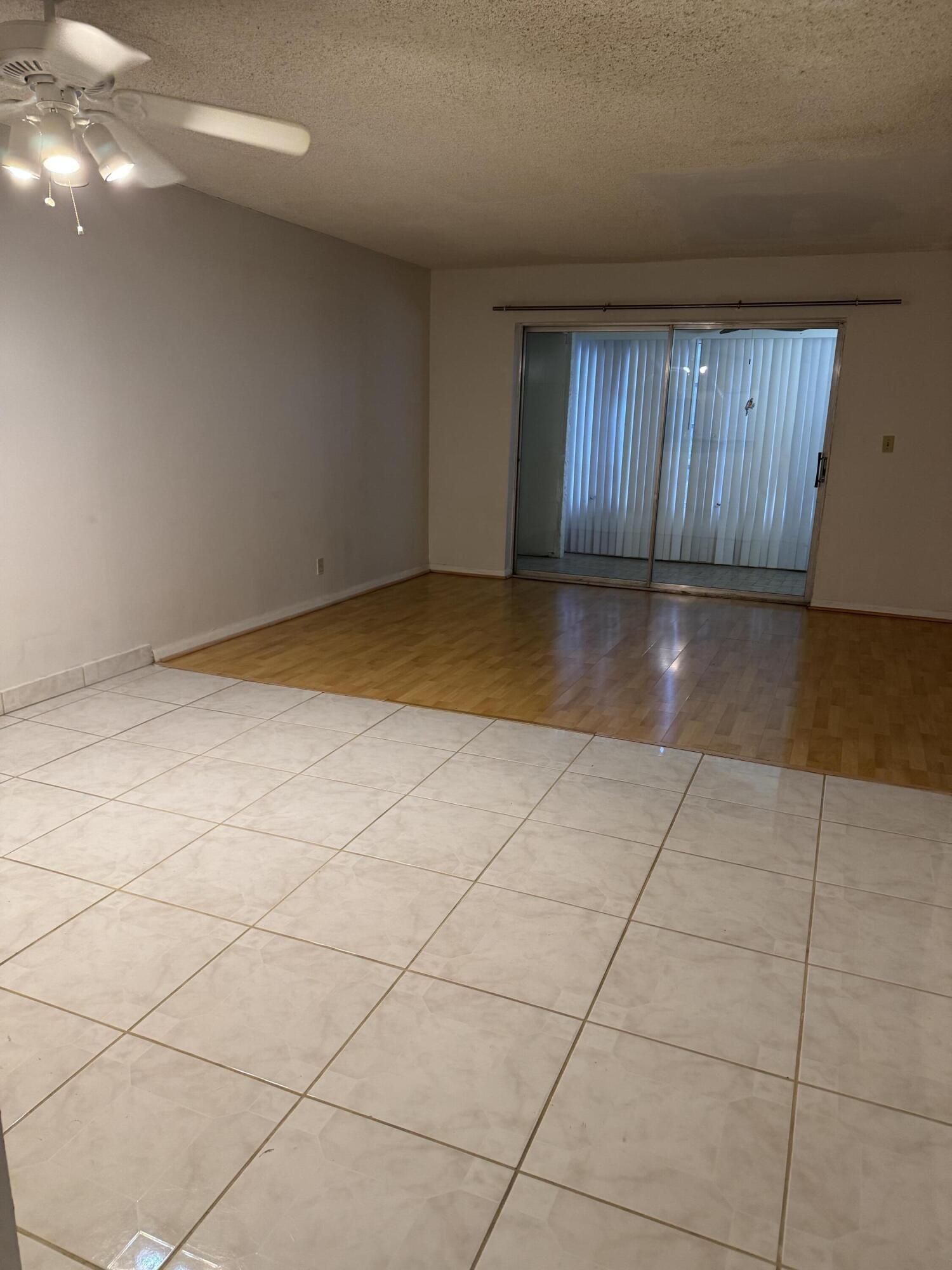 9374 Southwest 3rd Street, Unit 718 Boca Raton, FL 33428 - Photo 2 of 5 a view of a livingroom with an empty space and a window