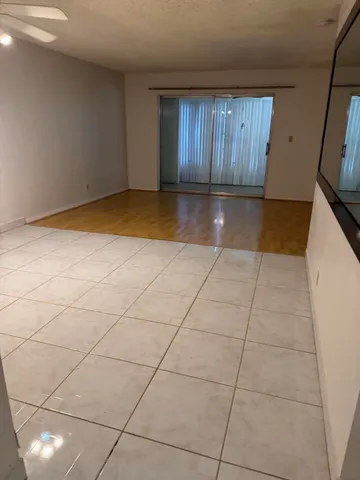 a view of a livingroom with an empty space and a window