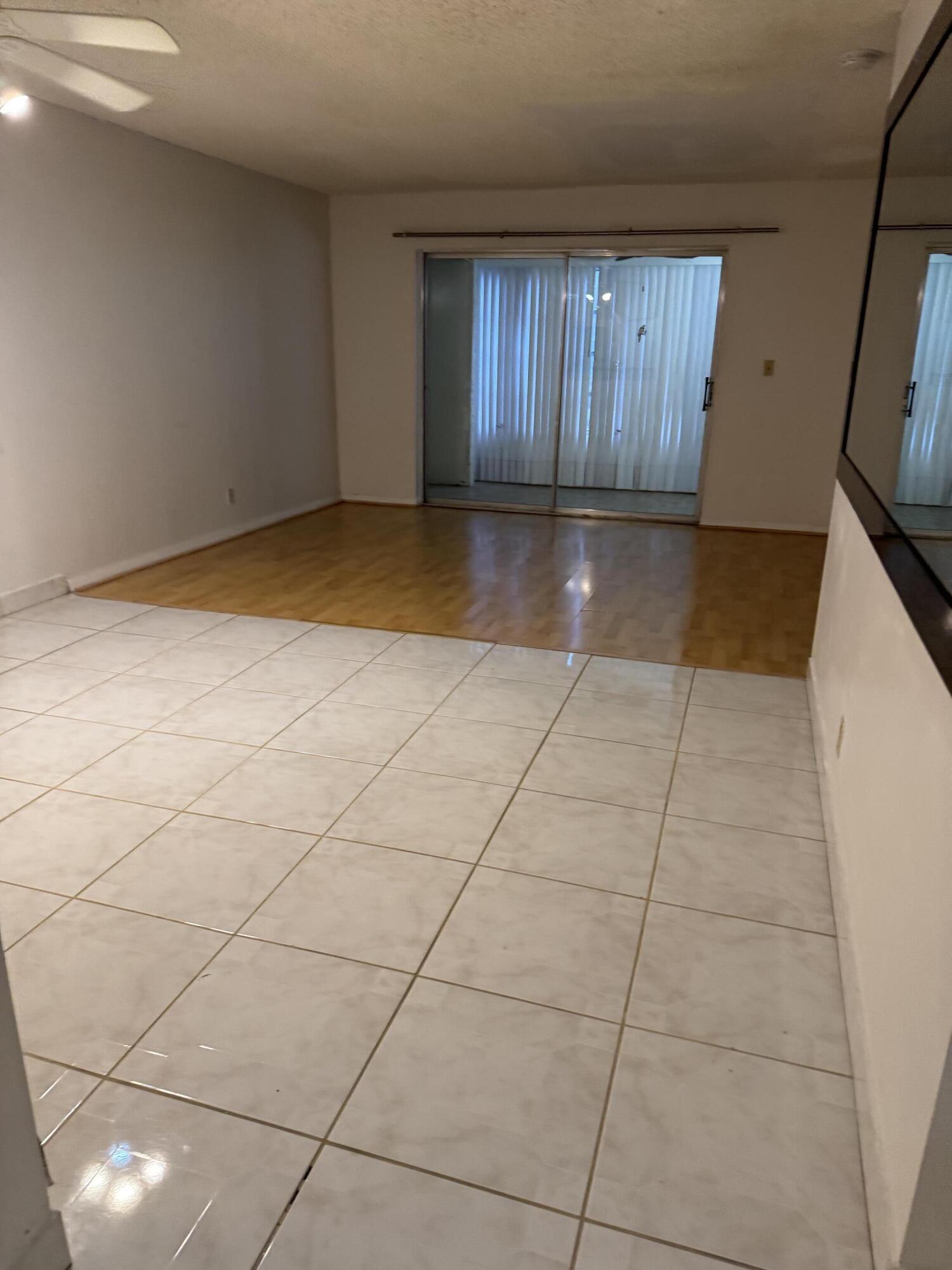 9374 Southwest 3rd Street, Unit 718 Boca Raton, FL 33428 - Photo 4 of 5 a view of a livingroom with an empty space and a window