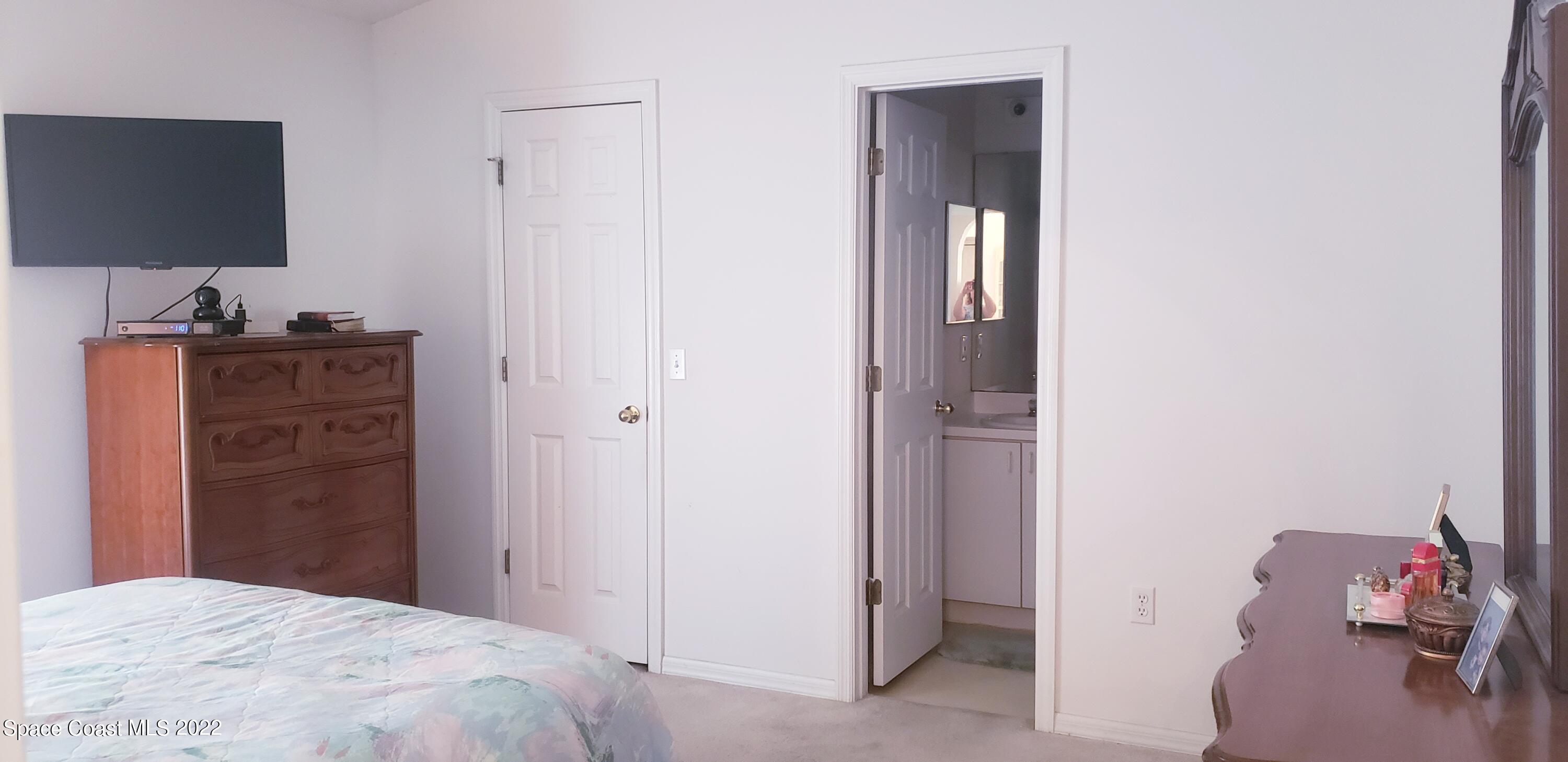 1260 Daton Road Southwest Palm Bay, FL 32908 - Photo 12 of 17 a bedroom with a bed and a flat screen tv