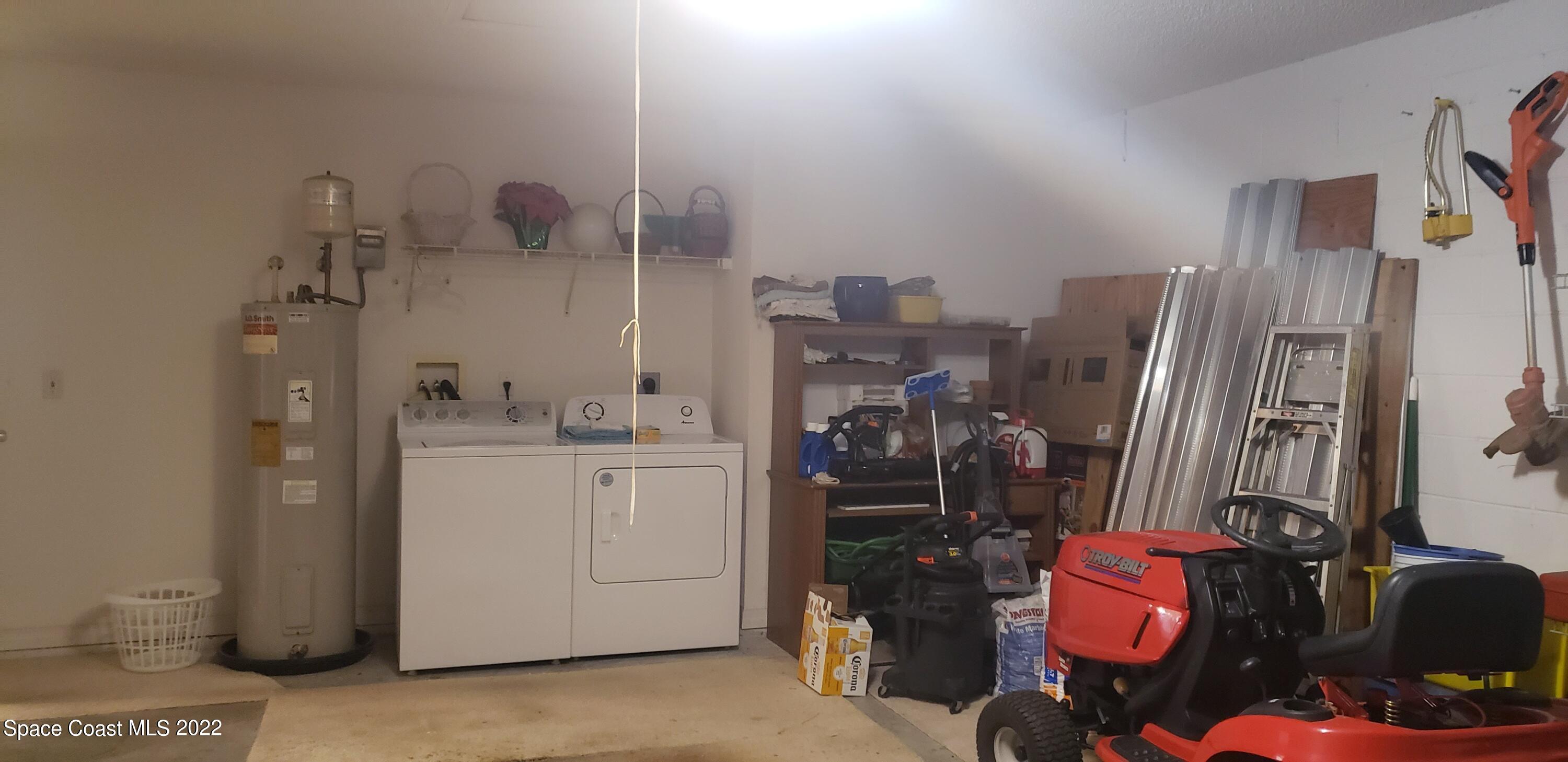 1260 Daton Road Southwest Palm Bay, FL 32908 - Photo 16 of 17 a room with water heater and wooden cabinets