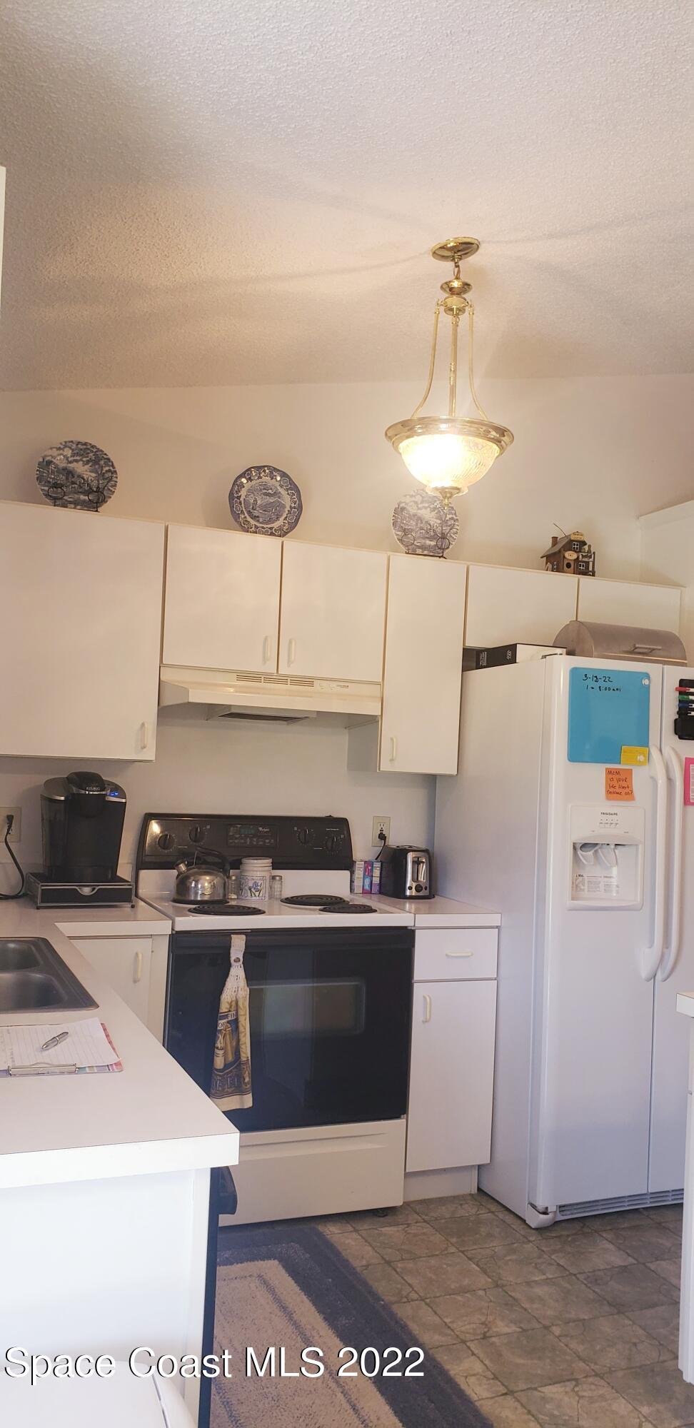 1260 Daton Road Southwest Palm Bay, FL 32908 - Photo 2 of 17 a kitchen with a stove a sink and a refrigerator