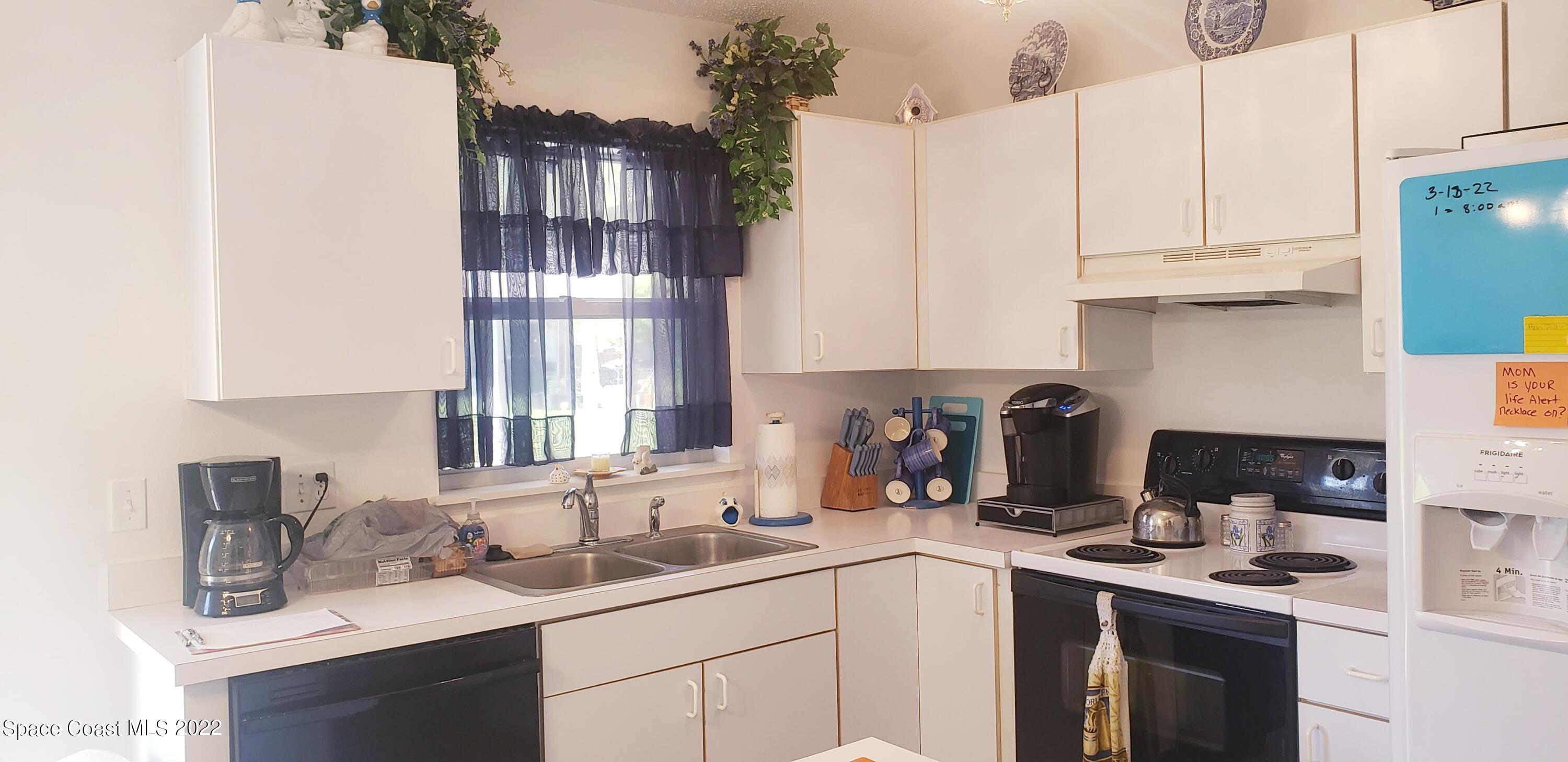 1260 Daton Road Southwest Palm Bay, FL 32908 - Photo 3 of 17 a kitchen with a sink dishwasher and cabinets
