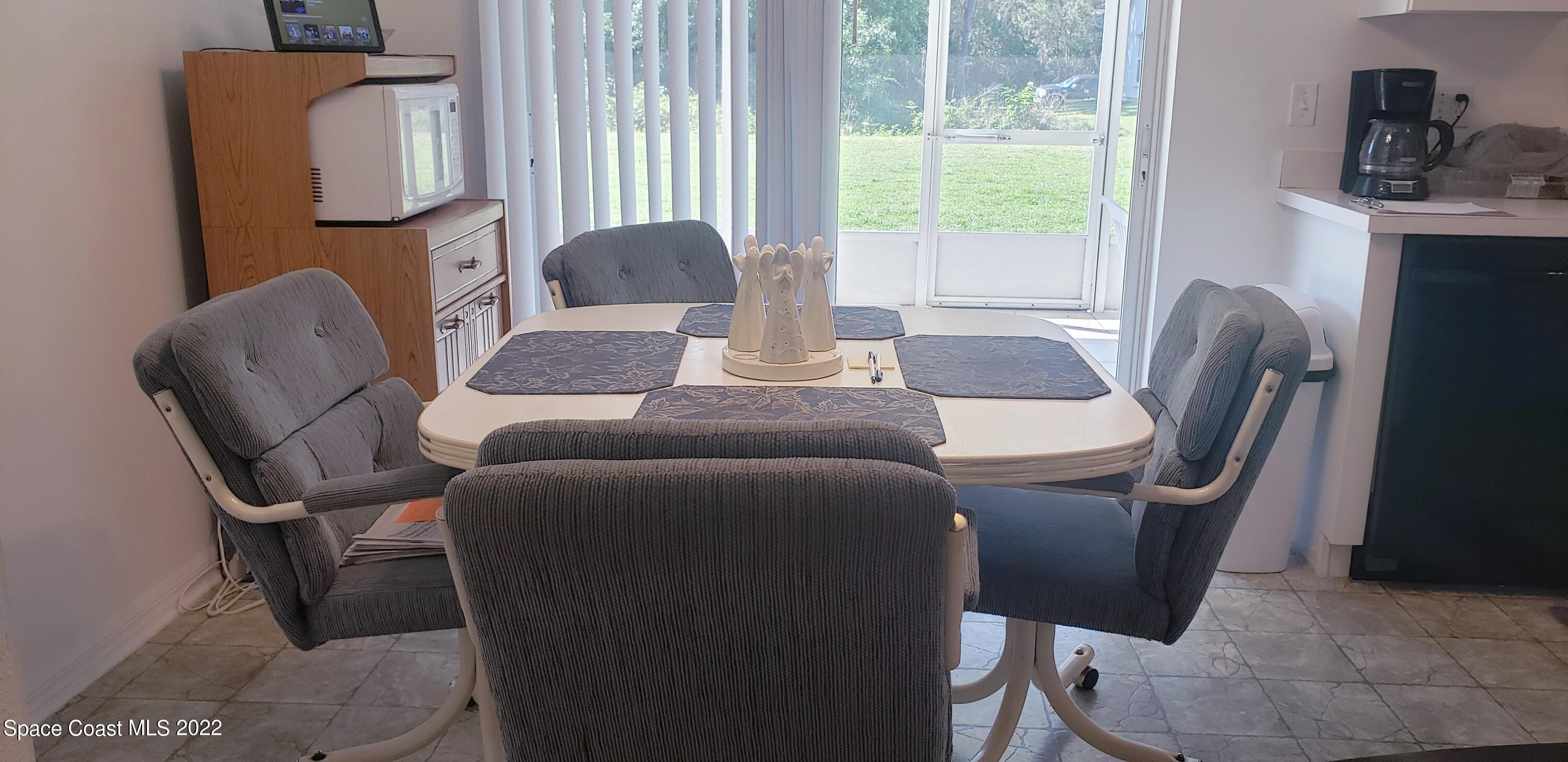 1260 Daton Road Southwest Palm Bay, FL 32908 - Photo 4 of 17 a dining room with furniture and a window