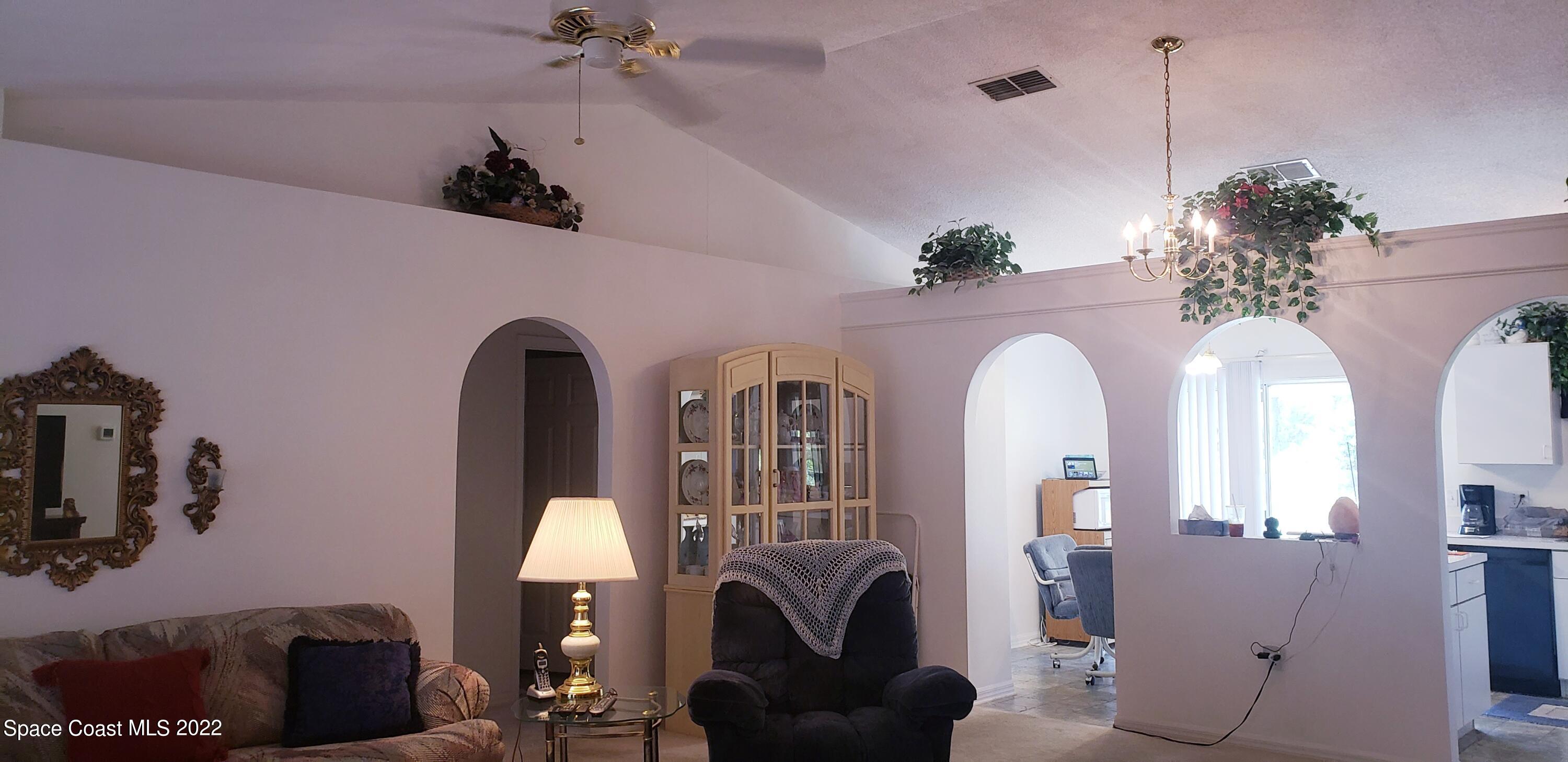 1260 Daton Road Southwest Palm Bay, FL 32908 - Photo 5 of 17 a living room with furniture and a chandelier