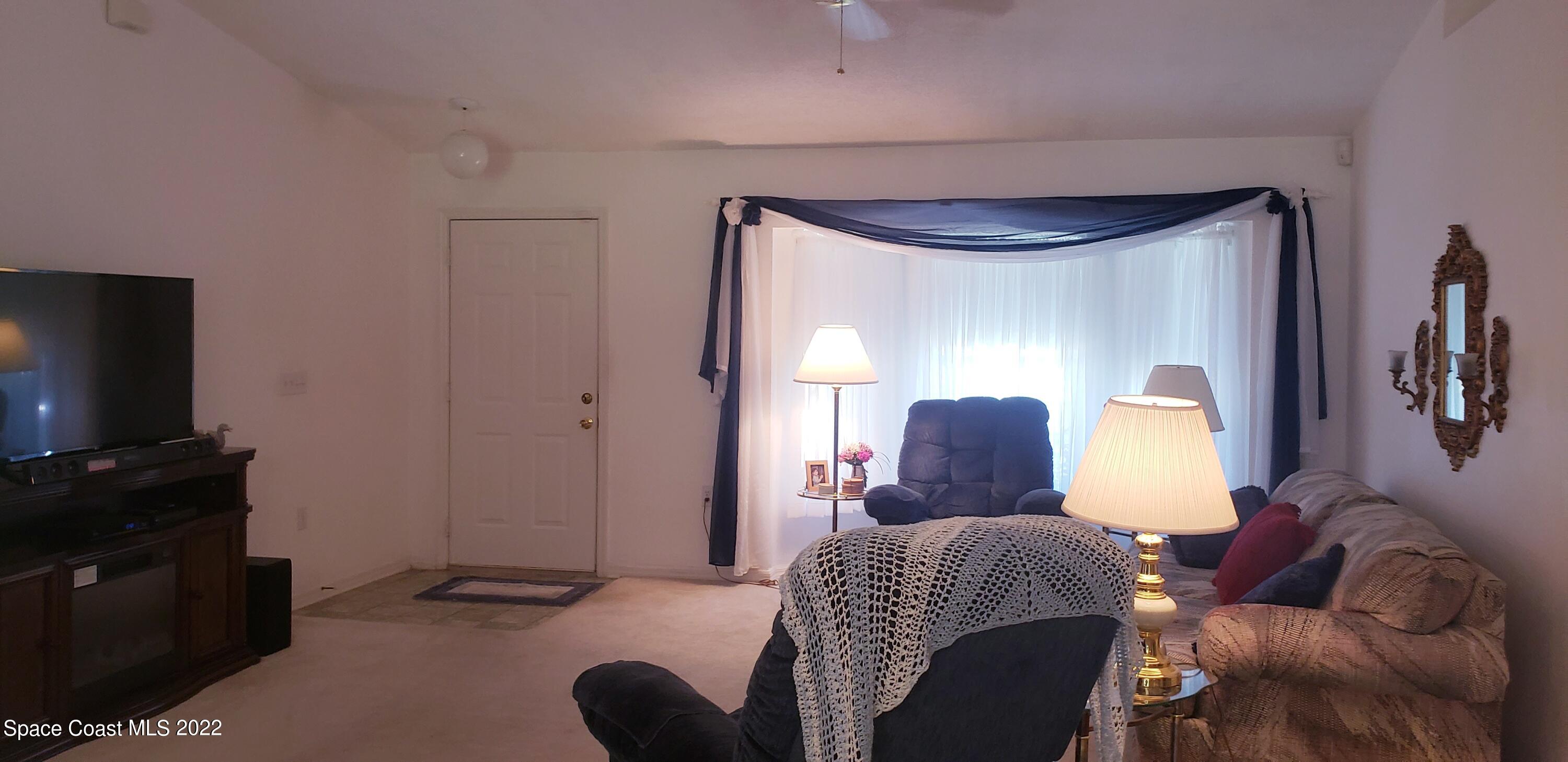 1260 Daton Road Southwest Palm Bay, FL 32908 - Photo 6 of 17 a bedroom with a bed and a television in it