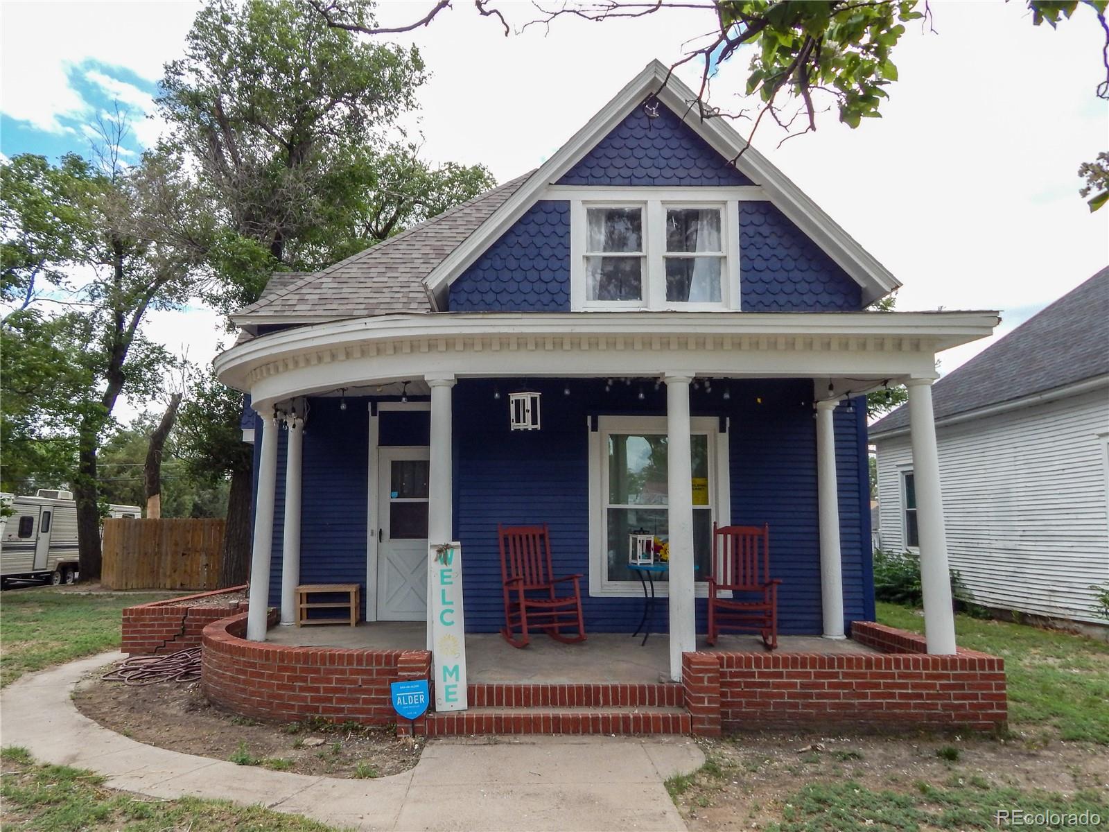 a front view of a house with garden