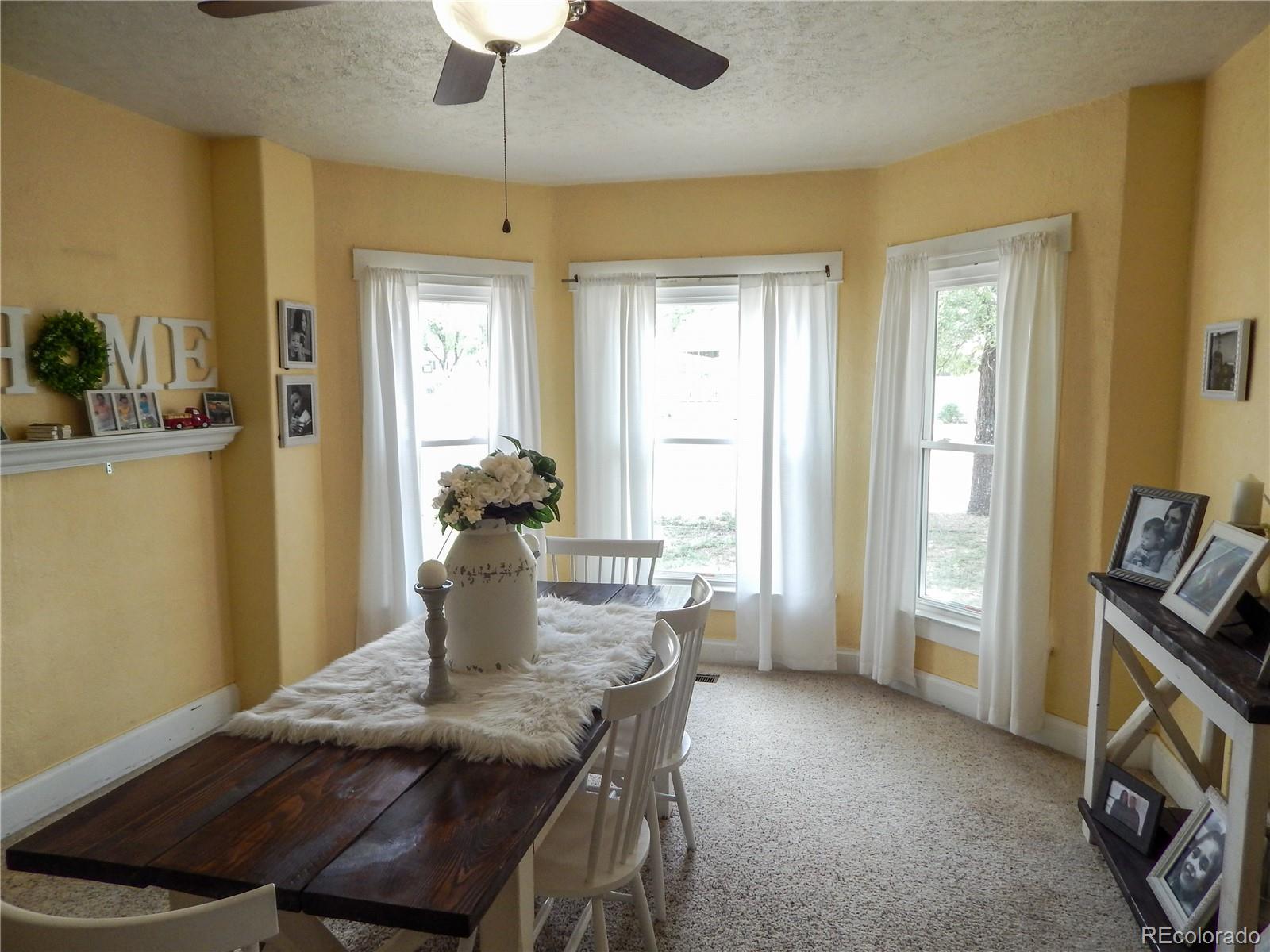 910 South Main Street Lamar, CO 81052 - Photo 12 of 37 a view of a dining room with furniture window and wooden floor