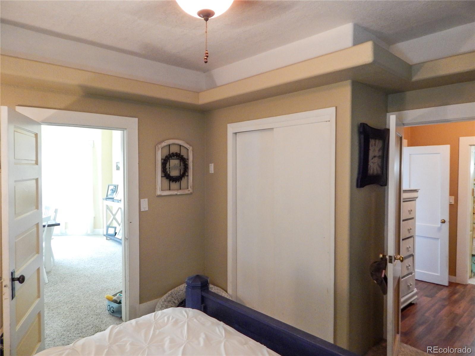 910 South Main Street Lamar, CO 81052 - Photo 14 of 37 a bedroom with a bed and a chandelier