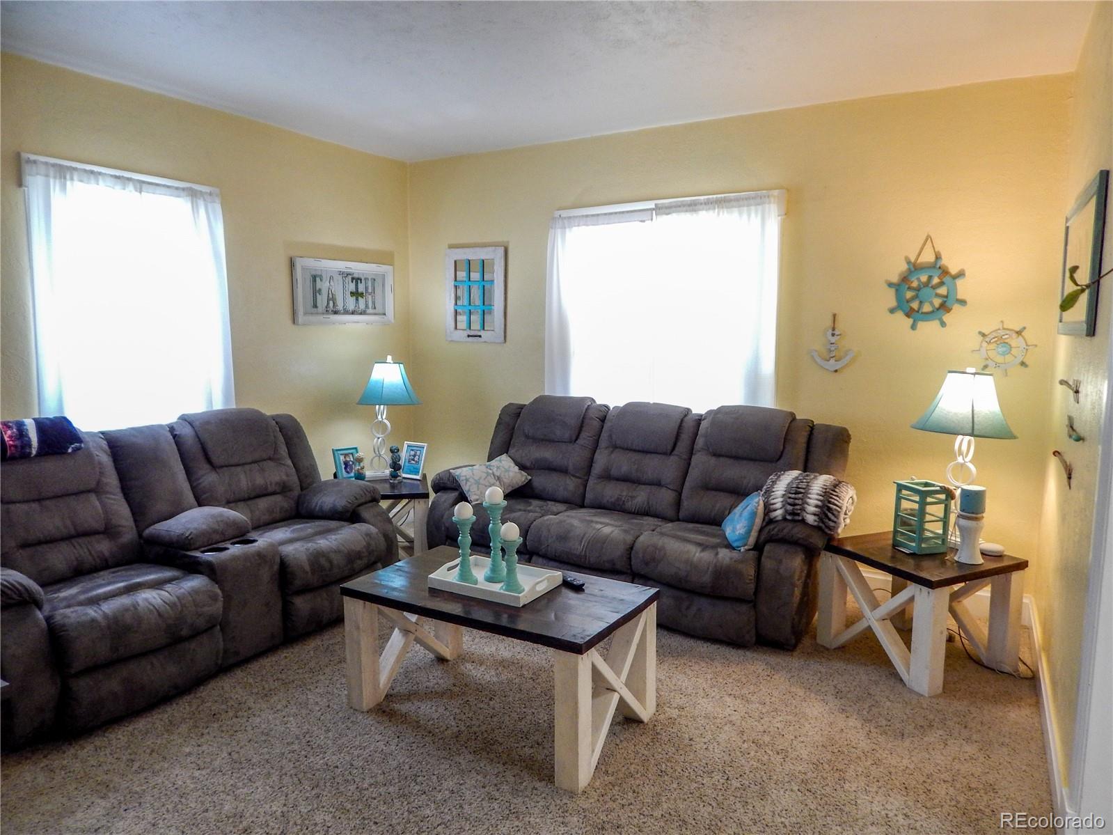 910 South Main Street Lamar, CO 81052 - Photo 16 of 37 a living room with furniture a lamp and a window