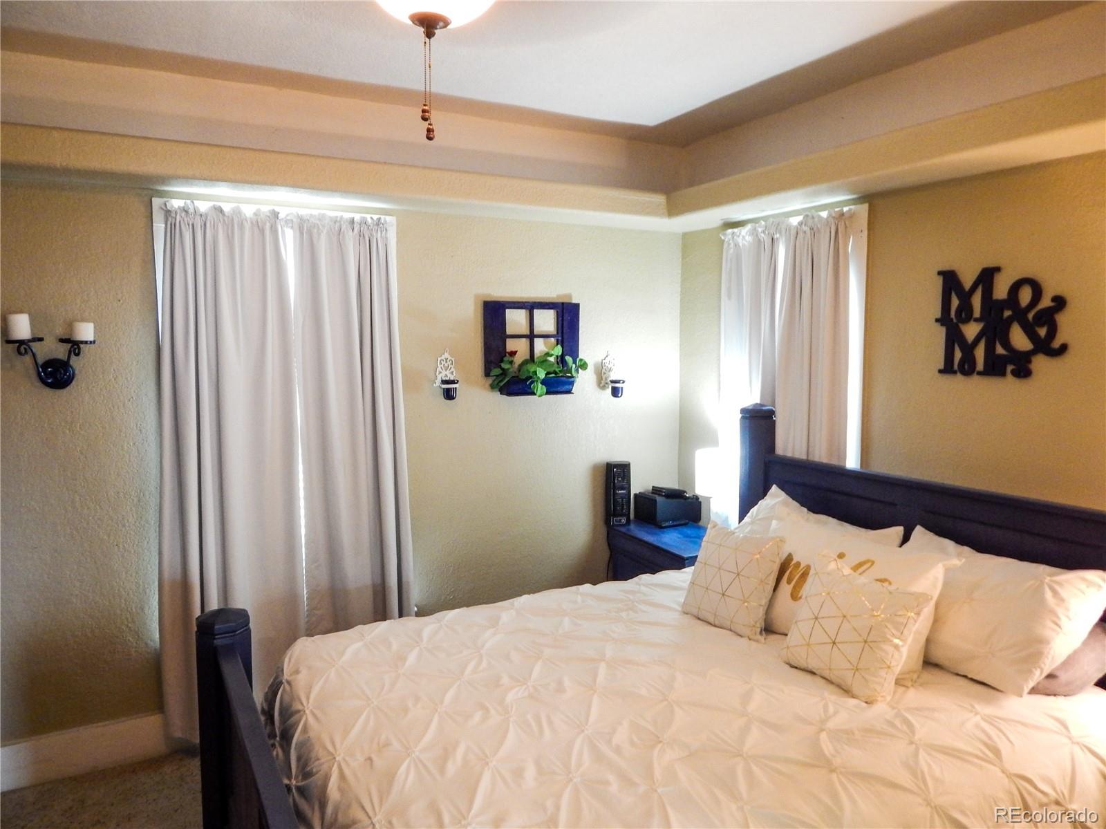 910 South Main Street Lamar, CO 81052 - Photo 17 of 37 a bedroom with a large bed and a window