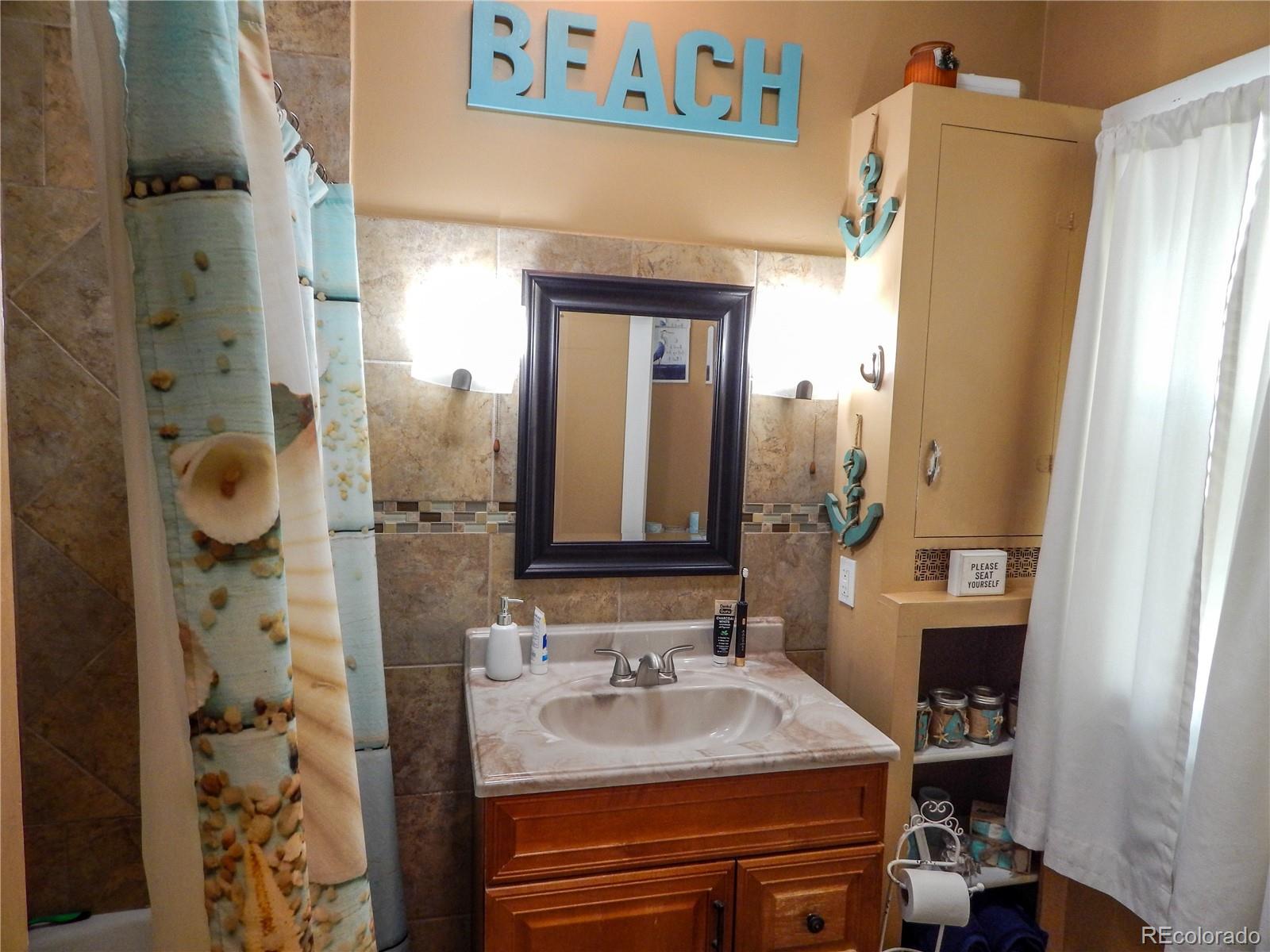 910 South Main Street Lamar, CO 81052 - Photo 19 of 37 a bathroom with a sink and a mirror