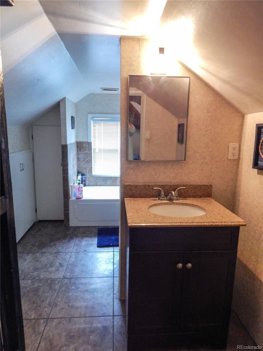 910 South Main Street Lamar, CO 81052 - Photo 21 of 37 a bathroom with a sink and a mirror
