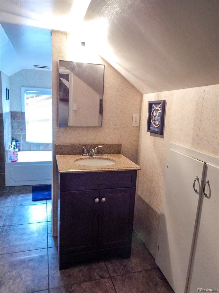 910 South Main Street Lamar, CO 81052 - Photo 22 of 37 a bathroom with a sink and a mirror