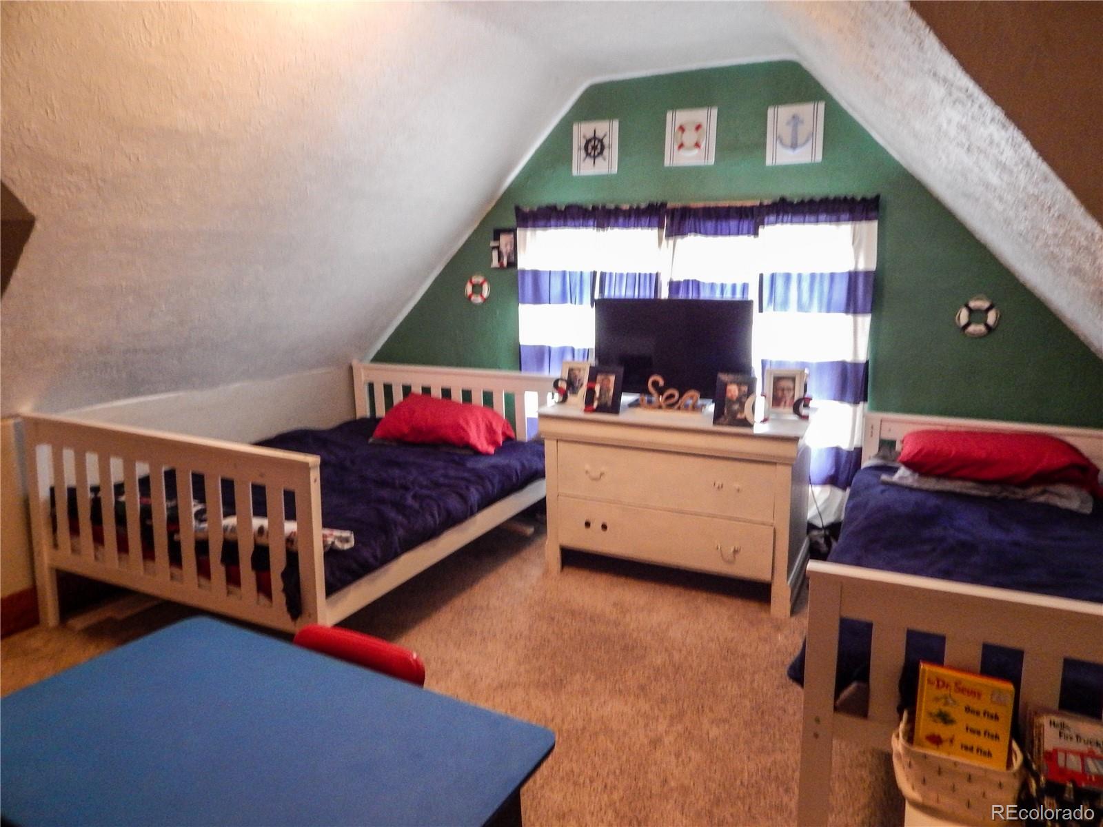 910 South Main Street Lamar, CO 81052 - Photo 24 of 37 a bedroom with a bed and a window