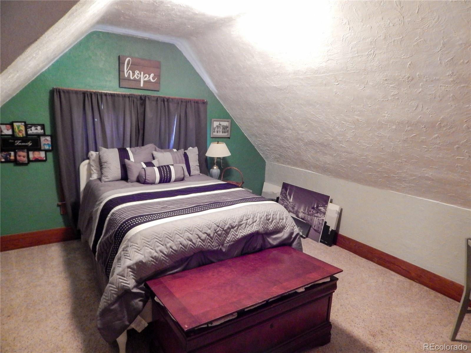 910 South Main Street Lamar, CO 81052 - Photo 26 of 37 a bedroom with a bed and a potted plant