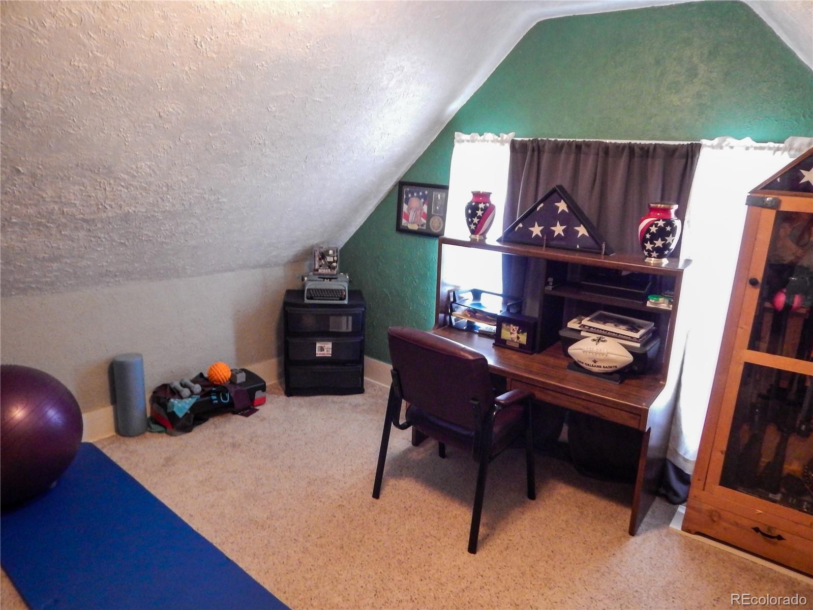 910 South Main Street Lamar, CO 81052 - Photo 30 of 37 a living room with furniture and a flat screen tv