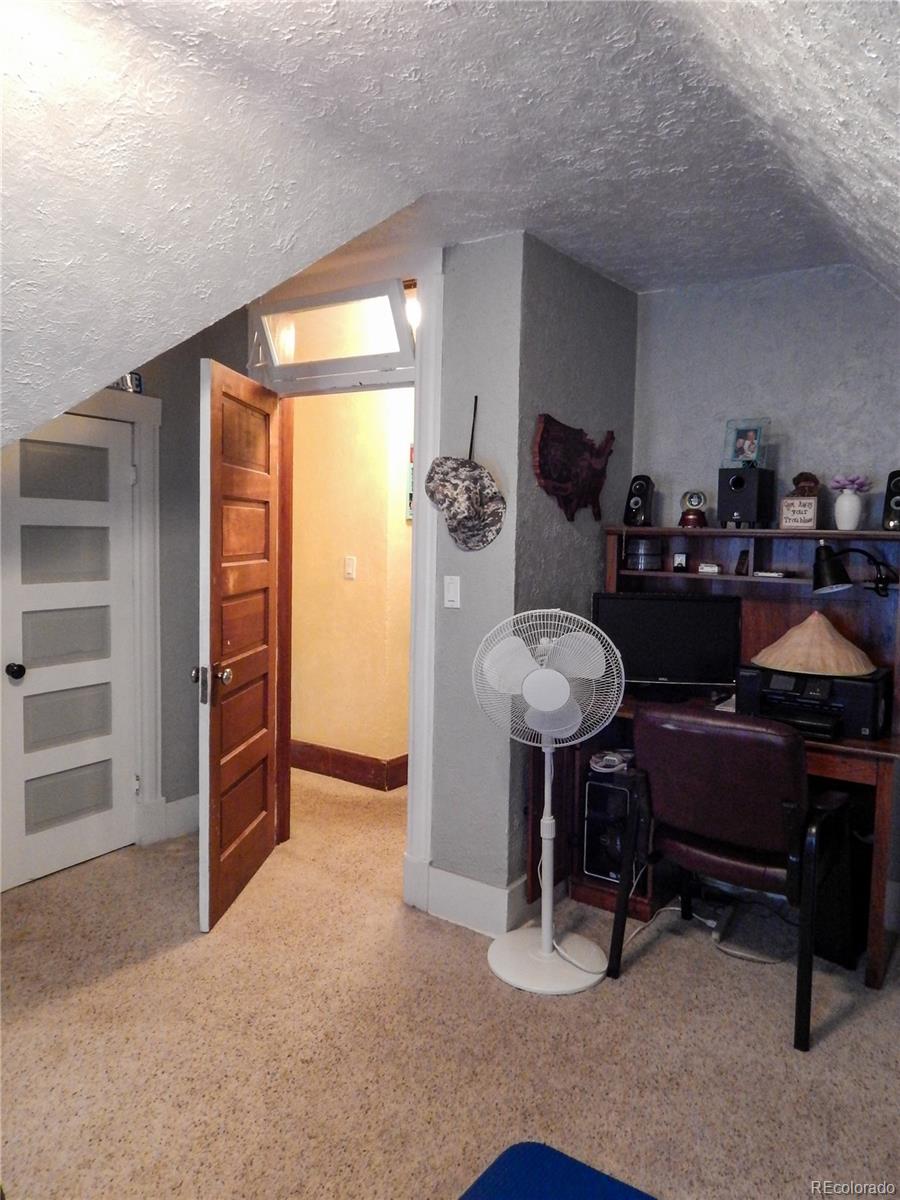 910 South Main Street Lamar, CO 81052 - Photo 32 of 37 a room with furniture and a window