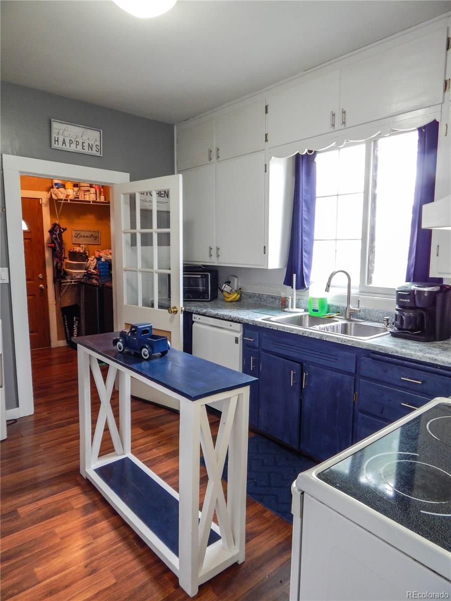 910 South Main Street Lamar, CO 81052 - Photo 7 of 37 a kitchen with stainless steel appliances granite countertop a stove a sink and a microwave
