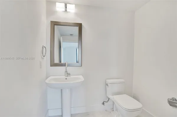 a bathroom with a sink toilet tub and shower