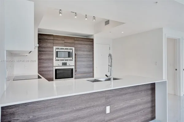 a kitchen with granite countertop stainless steel appliances and counter space