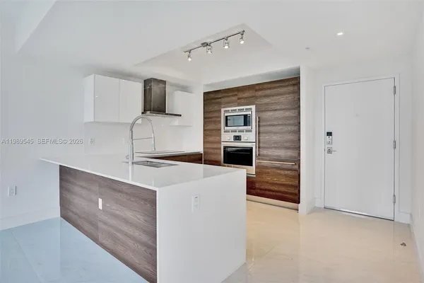 a kitchen with a sink and a large window