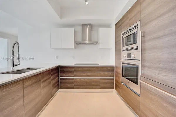 a kitchen with a sink and a stove top oven