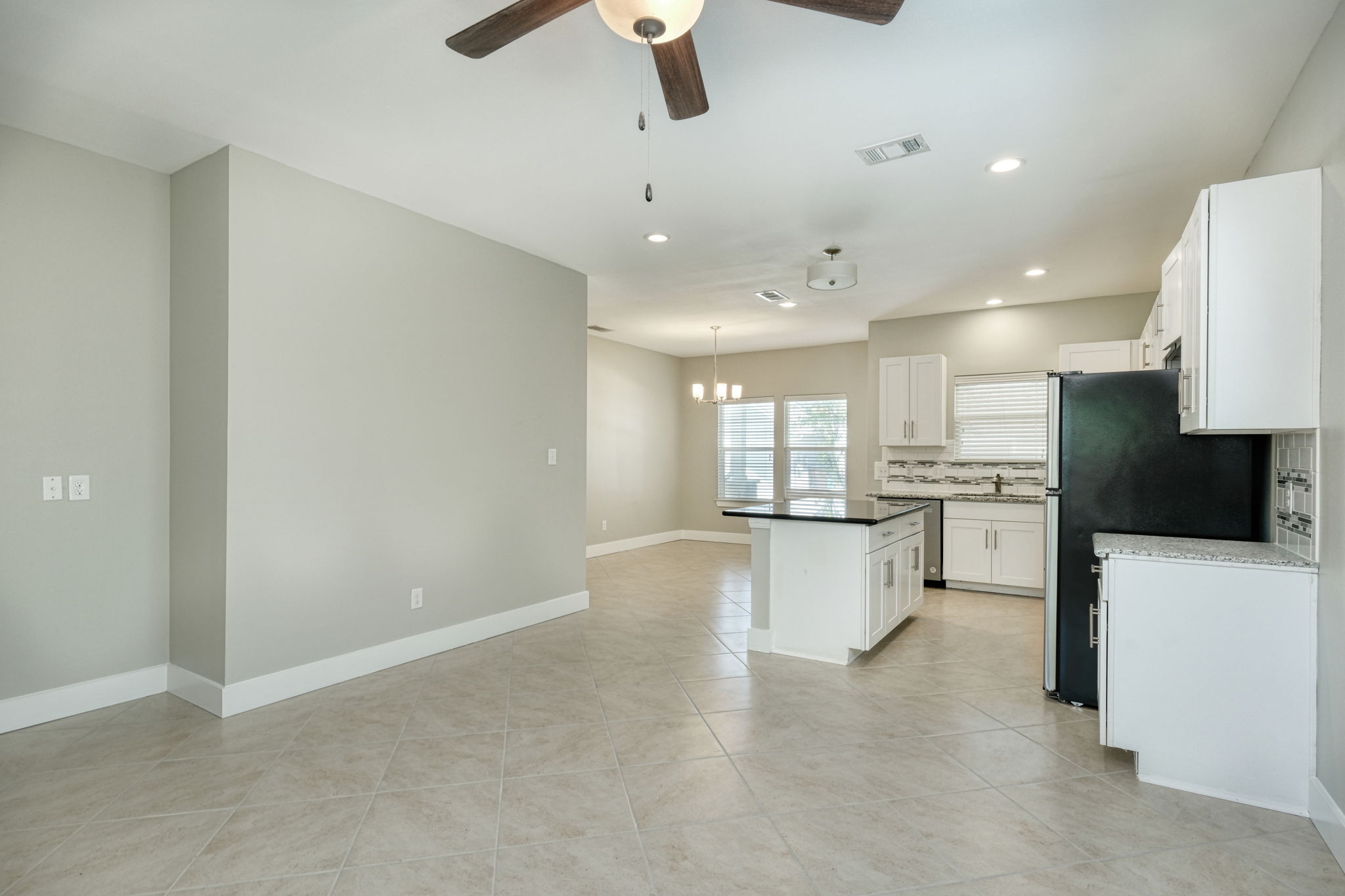 615 Spring Street, Unit 3 Round Rock, TX 78664 - Photo 1 of 14 An open-concept living space integrates a well-appointed kitchen with an inviting dining area.