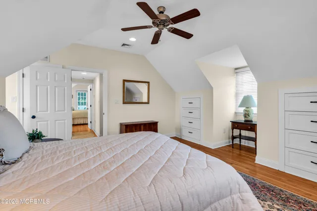a bedroom with a large bed and a chandelier
