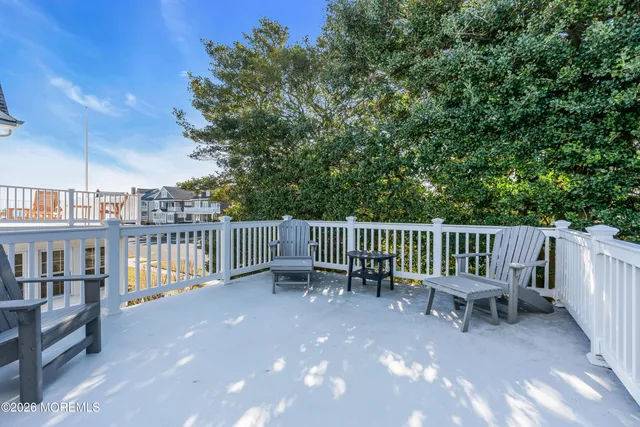 a view of a chair and table and wooden fence